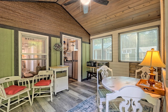 sunroom / solarium featuring wooden ceiling, ceiling fan, and vaulted ceiling