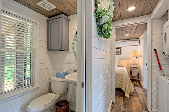 bathroom featuring visible vents, toilet, a wall mounted AC, and wood ceiling