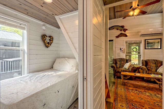 bedroom with lofted ceiling, wood ceiling, wood walls, and an AC wall unit