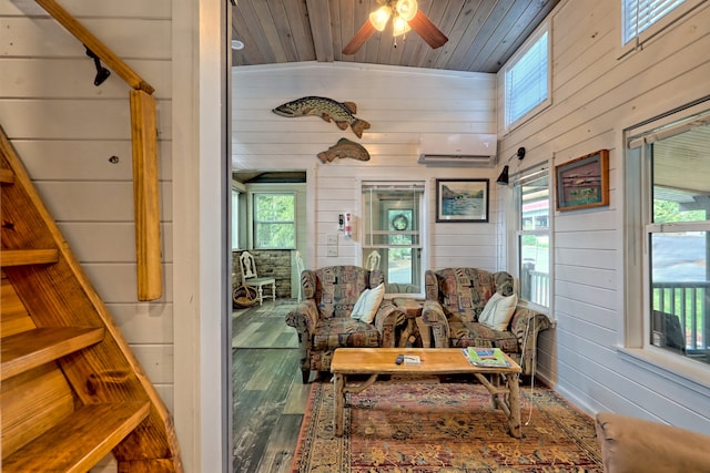 sunroom featuring a ceiling fan, an AC wall unit, and wooden ceiling