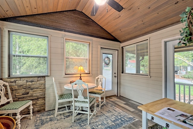 sunroom / solarium with lofted ceiling, wooden ceiling, and a ceiling fan