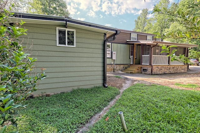 rear view of property featuring a sunroom