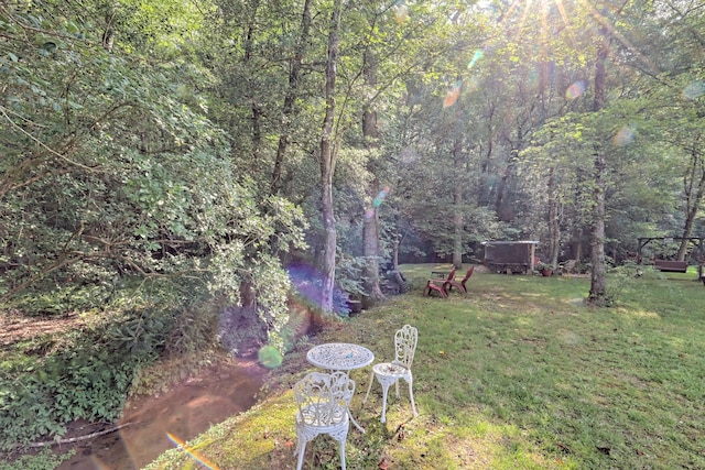 view of yard featuring a forest view