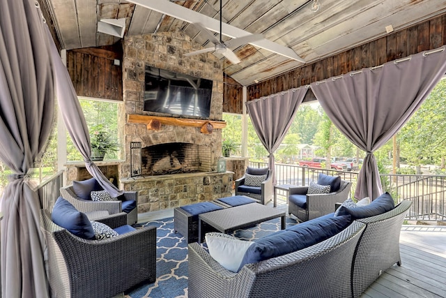 wooden deck with an outdoor living space with a fireplace