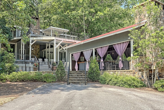 view of front of property featuring covered porch and a chimney