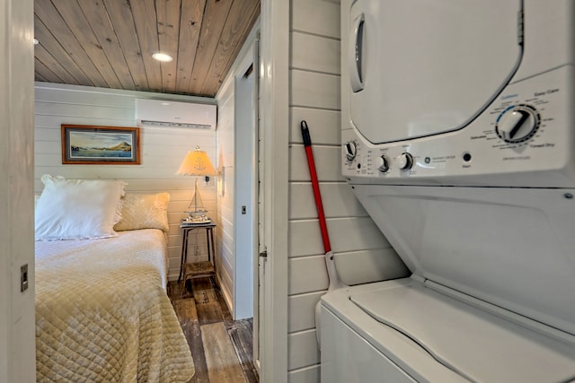 laundry area with stacked washer and clothes dryer, an AC wall unit, wooden walls, wood finished floors, and wooden ceiling