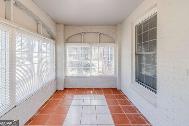 238 Howell Dr SW, Atlanta, GA 30331 - unfurnished sunroom with tile patterned floors and brick wall