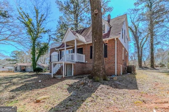 238 Howell Dr SW, Atlanta, GA 30331 - view of home's exterior featuring brick siding, stairs, a chimney, a wooden deck, and roof with shingles