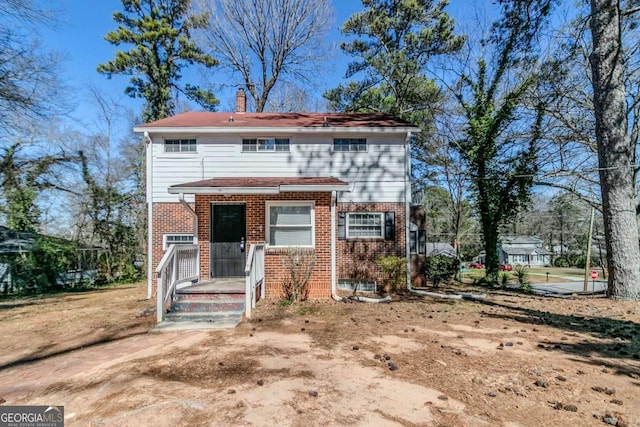 238 Howell Dr SW, Atlanta, GA 30331 - view of front of house featuring brick siding and a chimney