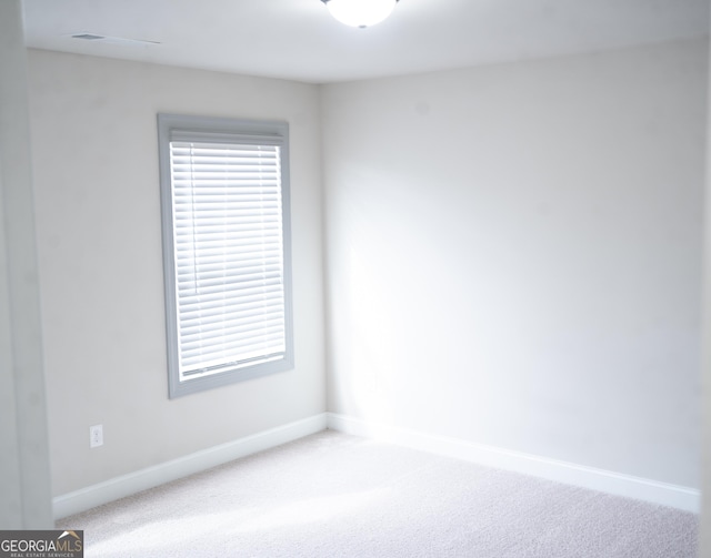 carpeted empty room with baseboards