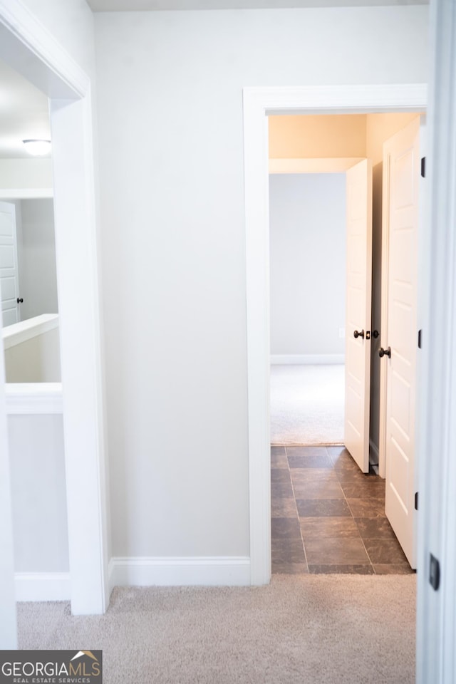 hall with carpet and baseboards