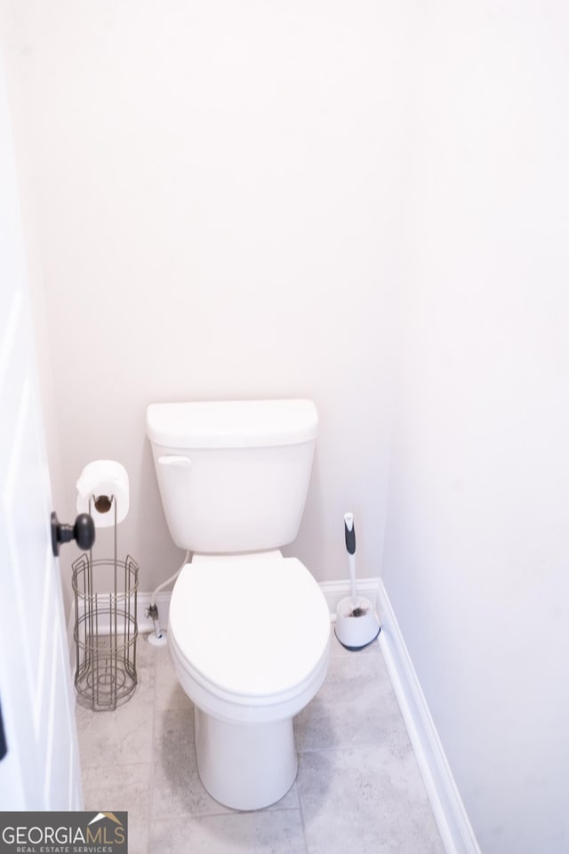 bathroom featuring toilet and baseboards