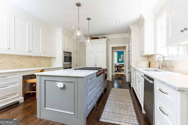 kitchen featuring a sink, a center island, and white cabinetry