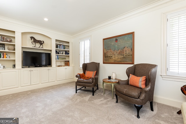 sitting room featuring a wealth of natural light, baseboards, light colored carpet, and crown molding