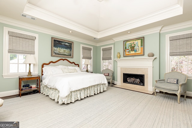 bedroom with baseboards, a fireplace, visible vents, and ornamental molding