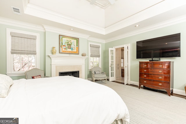 bedroom featuring crown molding, multiple windows, a fireplace, and visible vents