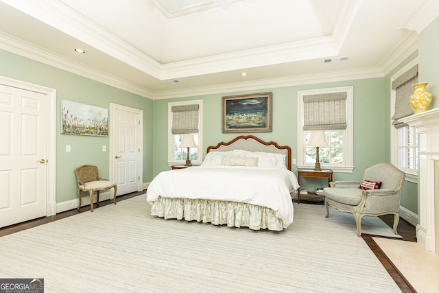 bedroom with wood finished floors, visible vents, baseboards, recessed lighting, and crown molding