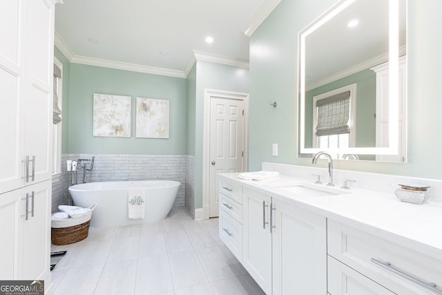 full bathroom with vanity, a freestanding tub, ornamental molding, tile patterned flooring, and tile walls