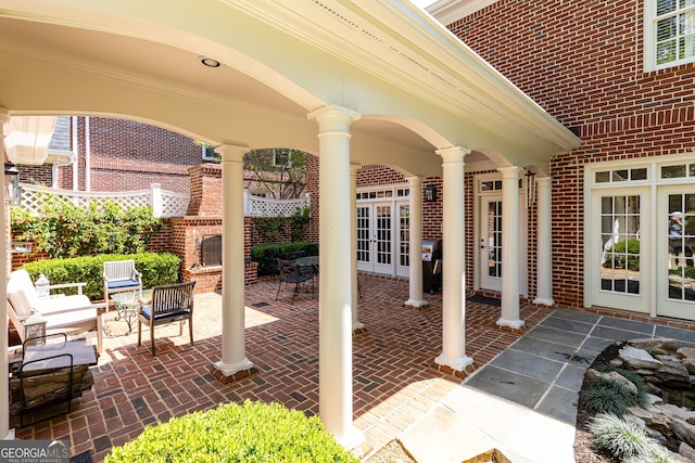 view of patio / terrace with outdoor dining space, french doors, and fence