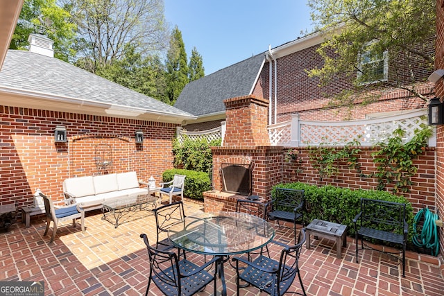 view of patio featuring an outdoor living space with a fireplace