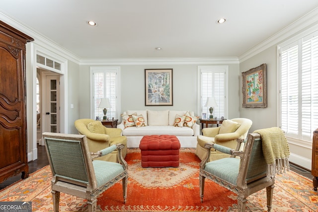 living room featuring a wealth of natural light, wood finished floors, and ornamental molding