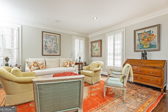 living room featuring a healthy amount of sunlight, wood finished floors, and ornamental molding