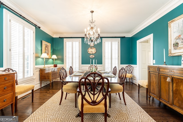 dining space with ornamental molding, dark wood-style flooring, a chandelier, and wainscoting