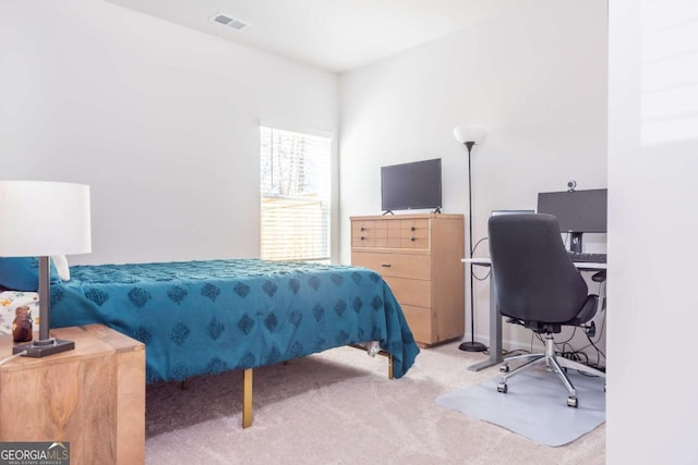 carpeted bedroom featuring visible vents