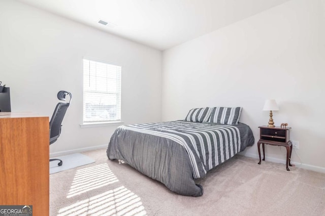 bedroom featuring carpet flooring, visible vents, and baseboards