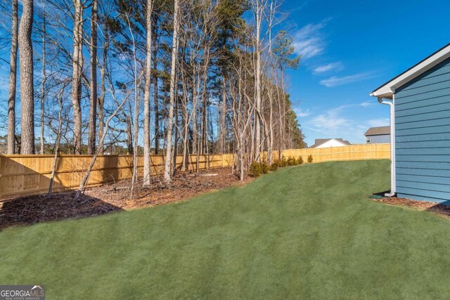 view of yard with a fenced backyard