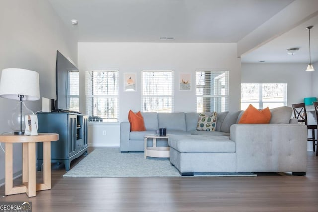 living room with wood finished floors and visible vents