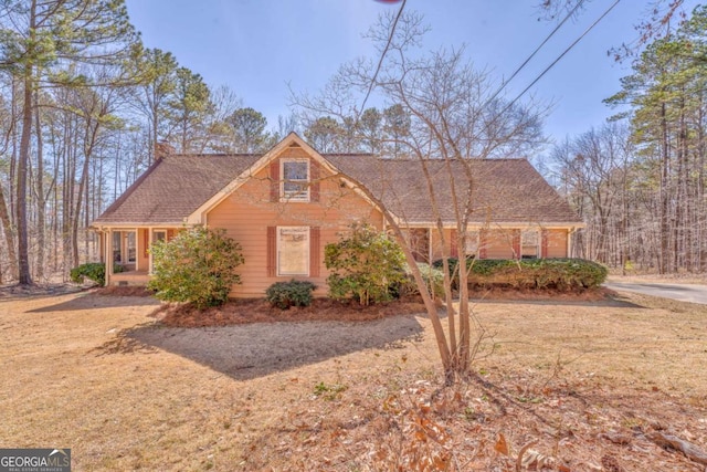 view of front of home with a shingled roof