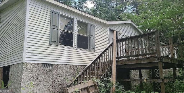 view of side of property featuring stairway