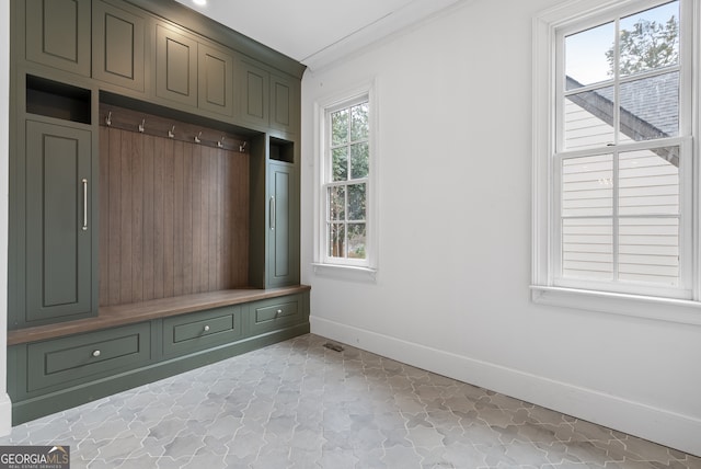 mudroom featuring baseboards and crown molding