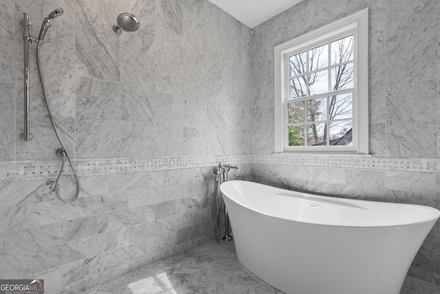 full bathroom featuring a soaking tub, marble finish floor, and tiled shower