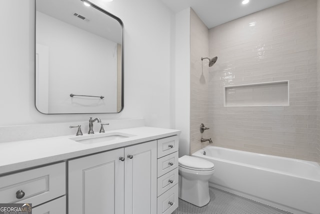 bathroom with visible vents, toilet, washtub / shower combination, vanity, and tile patterned floors