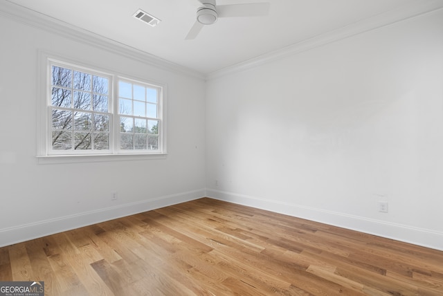 unfurnished room featuring baseboards, visible vents, a ceiling fan, ornamental molding, and light wood-type flooring