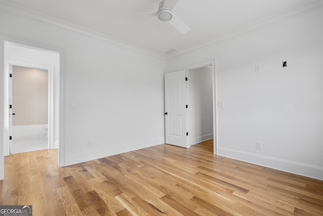 spare room featuring baseboards, light wood-type flooring, a ceiling fan, and crown molding