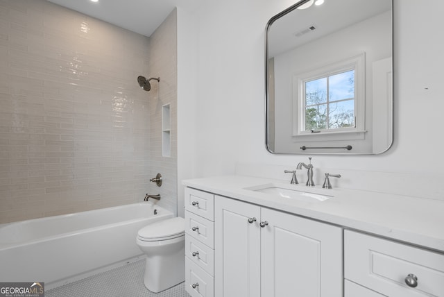 bathroom featuring toilet, visible vents, vanity, tile patterned floors, and washtub / shower combination