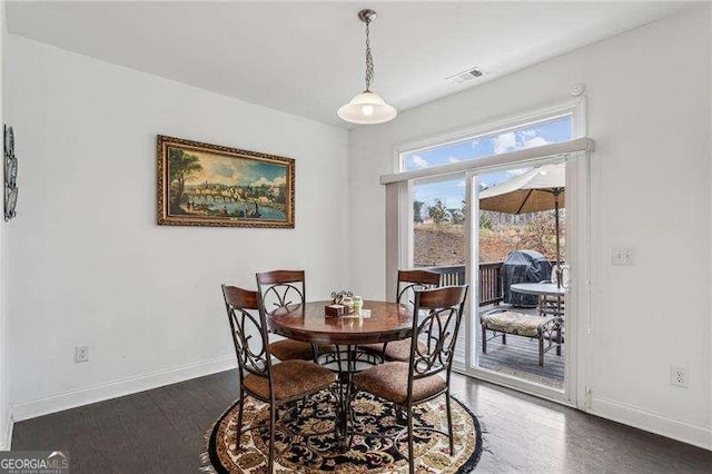 dining space with visible vents, baseboards, and dark wood-type flooring