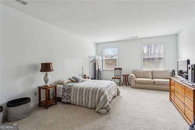 bedroom with visible vents and light colored carpet