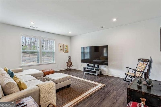 living area with recessed lighting, dark wood finished floors, visible vents, and baseboards