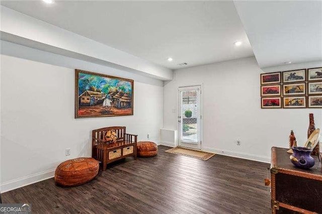 living area with recessed lighting, wood finished floors, visible vents, and baseboards