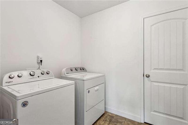 laundry area featuring laundry area, independent washer and dryer, and baseboards