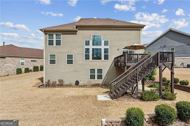 back of property with stairs and a wooden deck