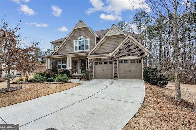 craftsman house with a garage, concrete driveway, and brick siding