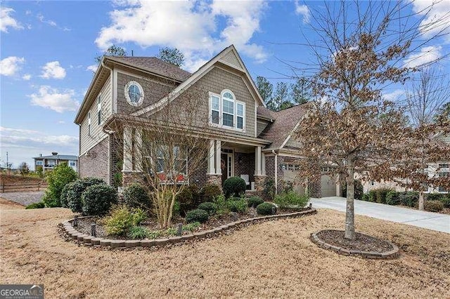 craftsman-style home featuring driveway, a garage, and brick siding