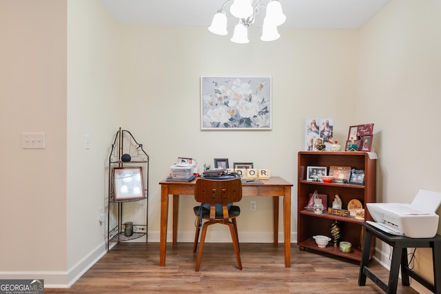 home office with a notable chandelier, baseboards, and wood finished floors