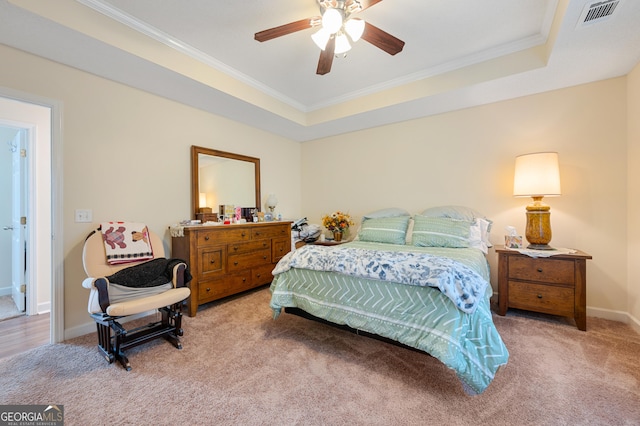 bedroom featuring carpet floors, visible vents, a raised ceiling, and crown molding