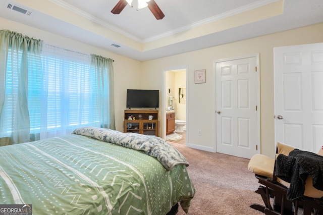 bedroom with visible vents, baseboards, ornamental molding, carpet, and a tray ceiling